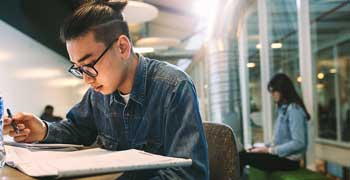 Male student working on his dissertation title